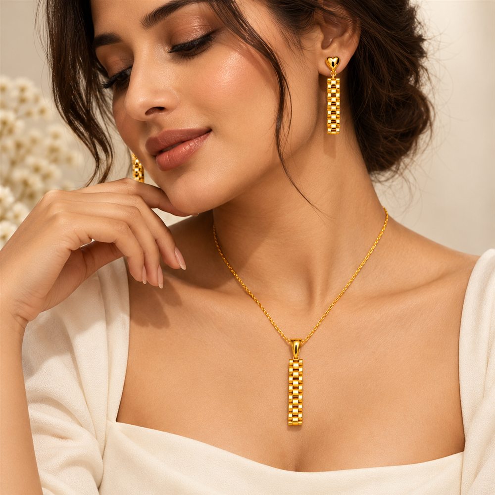 Model wearing a geometric gold pendant set